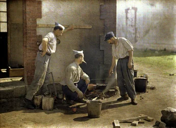 Three French soldiers cooking lunch on an open fire, Soissons, Aisne, France, 1917